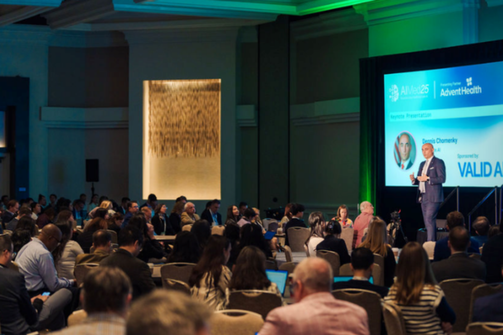 Speaker presenting AI healthcare insights to attendees at AIMed 2025