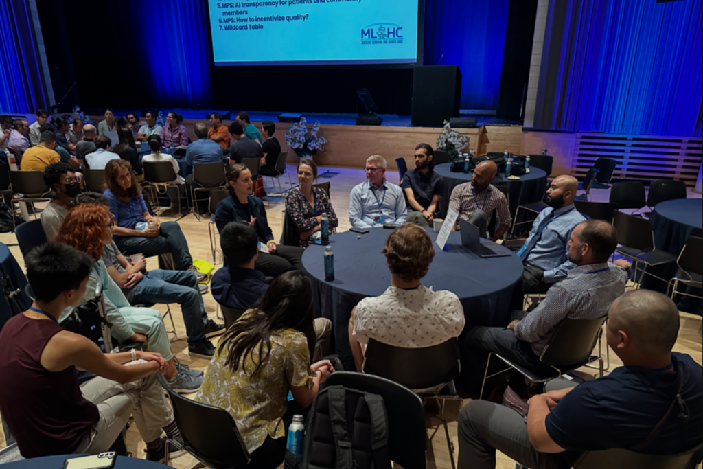 Attendees participating in a roundtable discussion at MLHC
