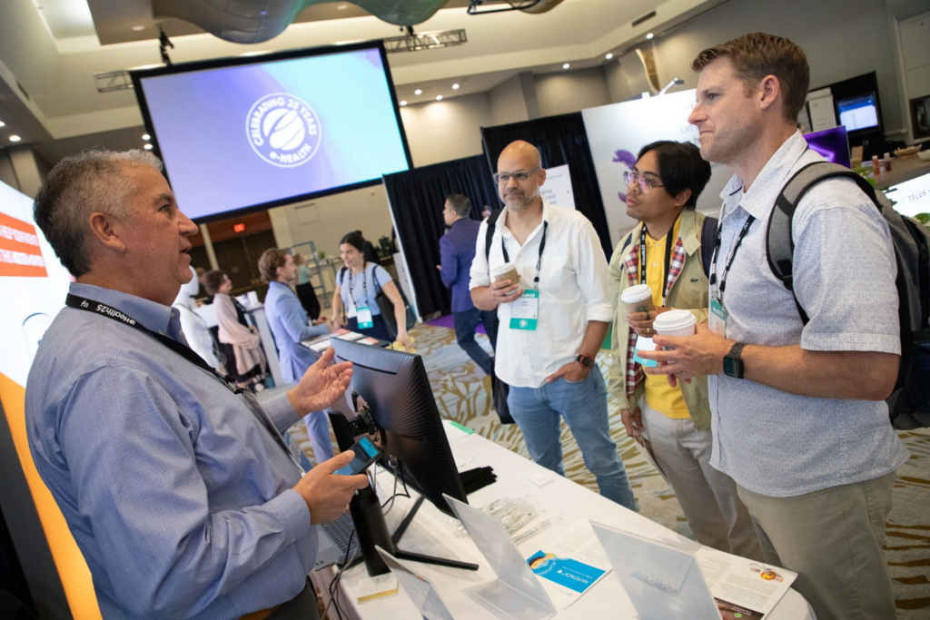 Exhibitor and attendees networking at the booth space of e-Health Conference &amp; Tradeshow 2025