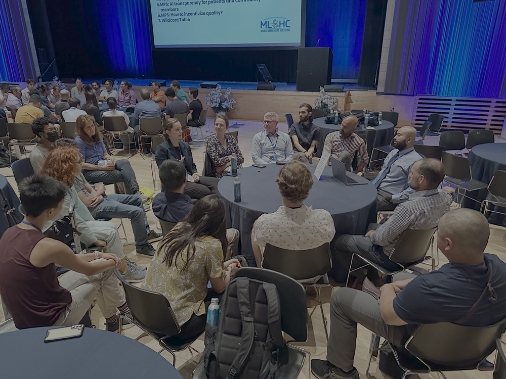 Conference attendees engaged during a roundtable discussion at the Machine Learning for Healthcare conference