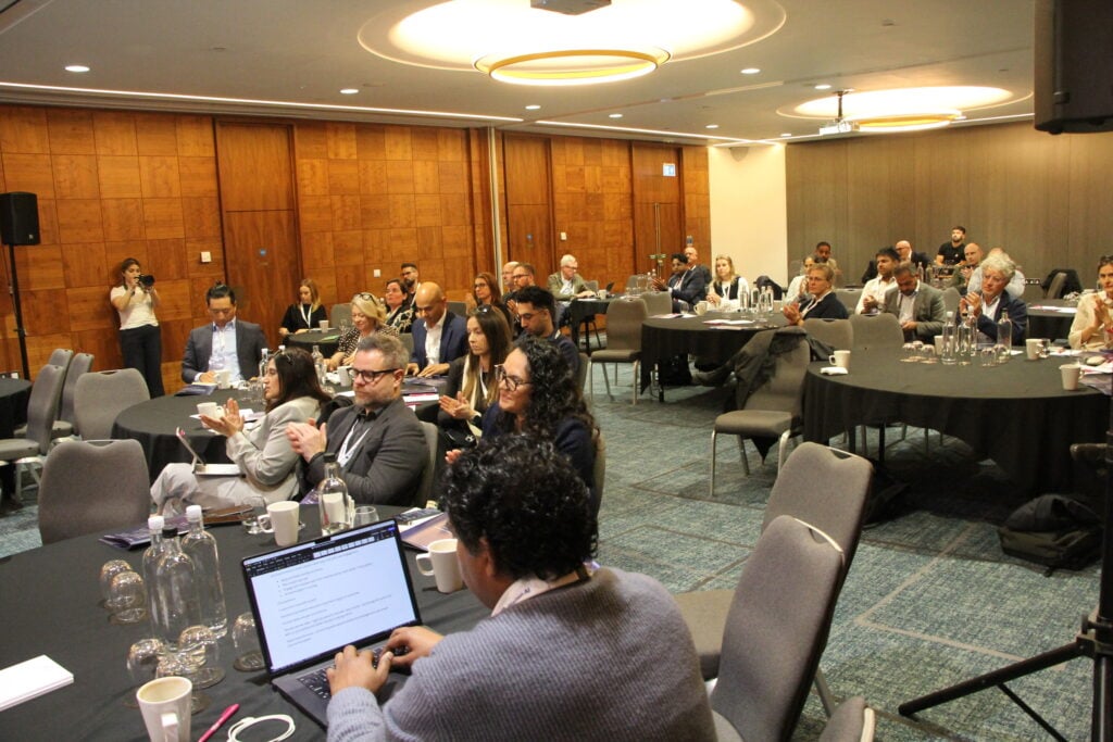 A conference room full of attendees for the World Health AI Forum