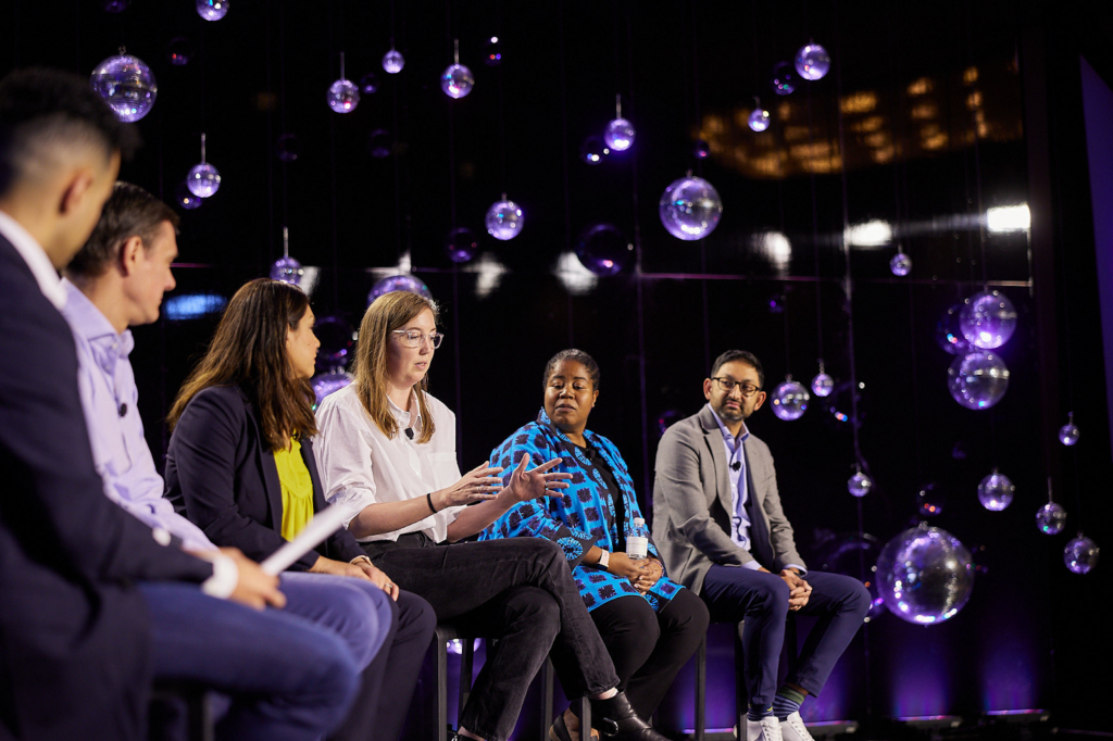 Line of panelist on discussion at HLTH Conference