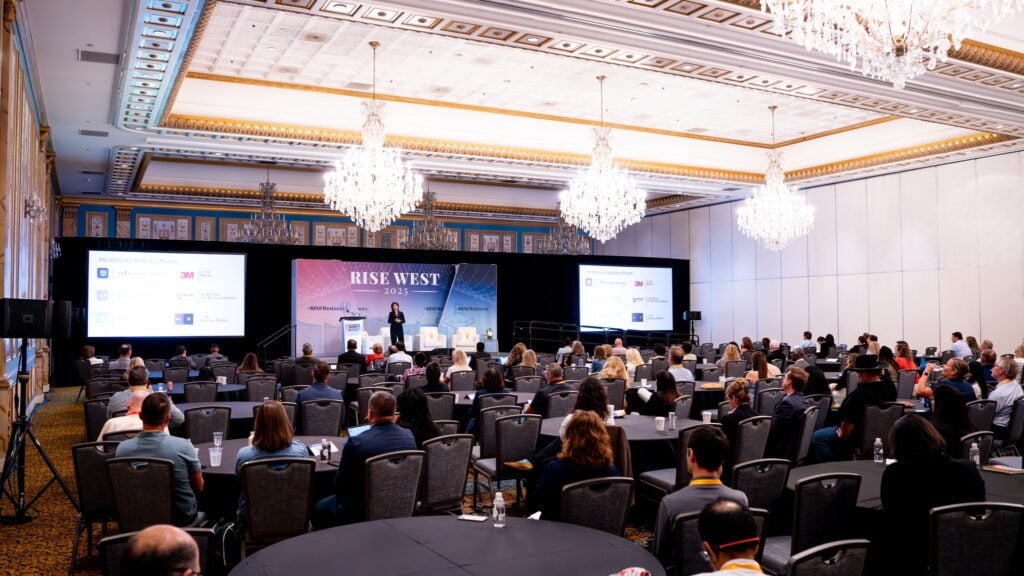 Speaker sharing insights on stage at the RISE West Conference