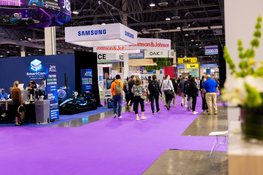Attendees exploring exhibition booths at HLTH USA